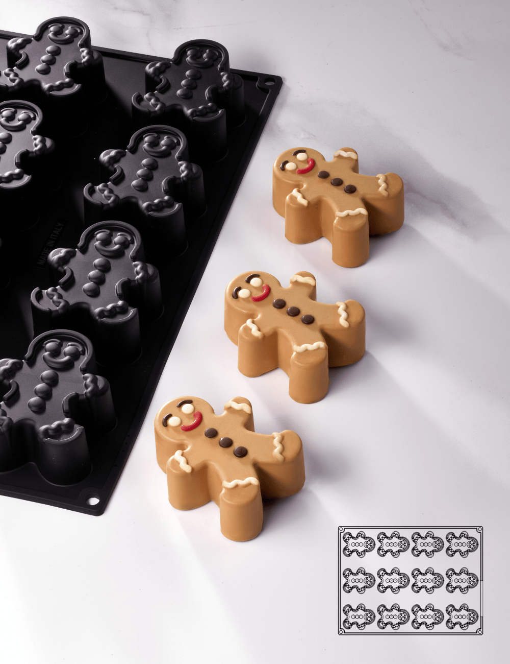 Moule Pavoflex Gingerman avec finitions chocolat détaillées (yeux, boutons, sourire) et schéma d'implantation des 12 empreintes