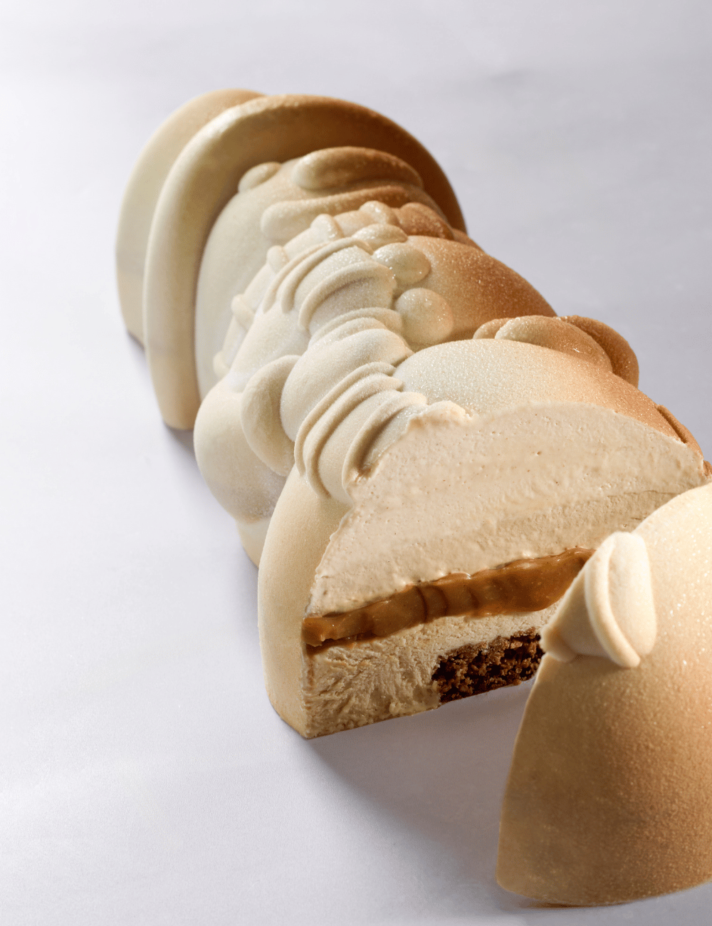 Frosty Yule log cross-section: mousse, caramel and crunchy biscuit base